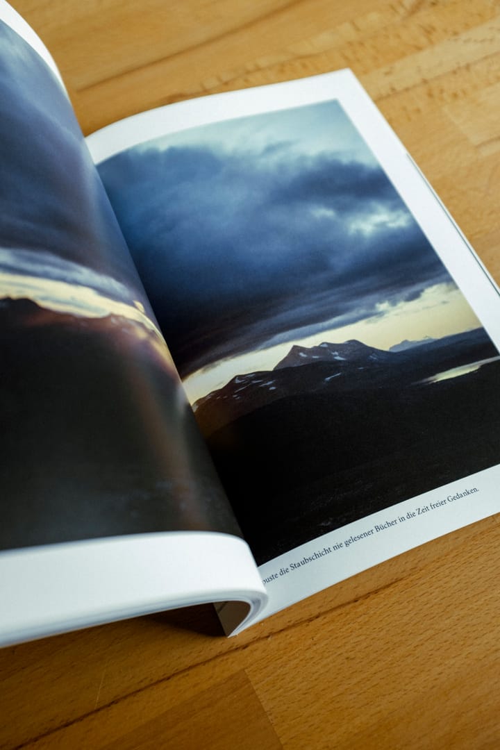 Open spread with a cloudy mountain landscape