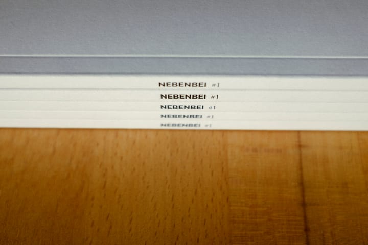 A stack of Nebenbei copies, spines facing the camera