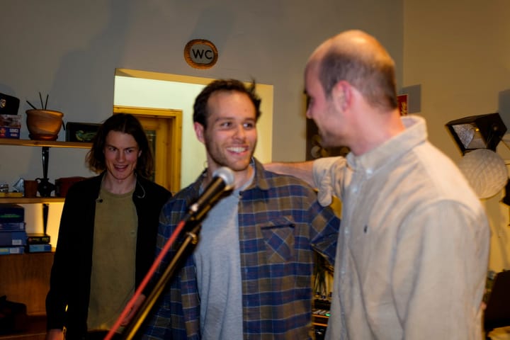Three band members laughing together